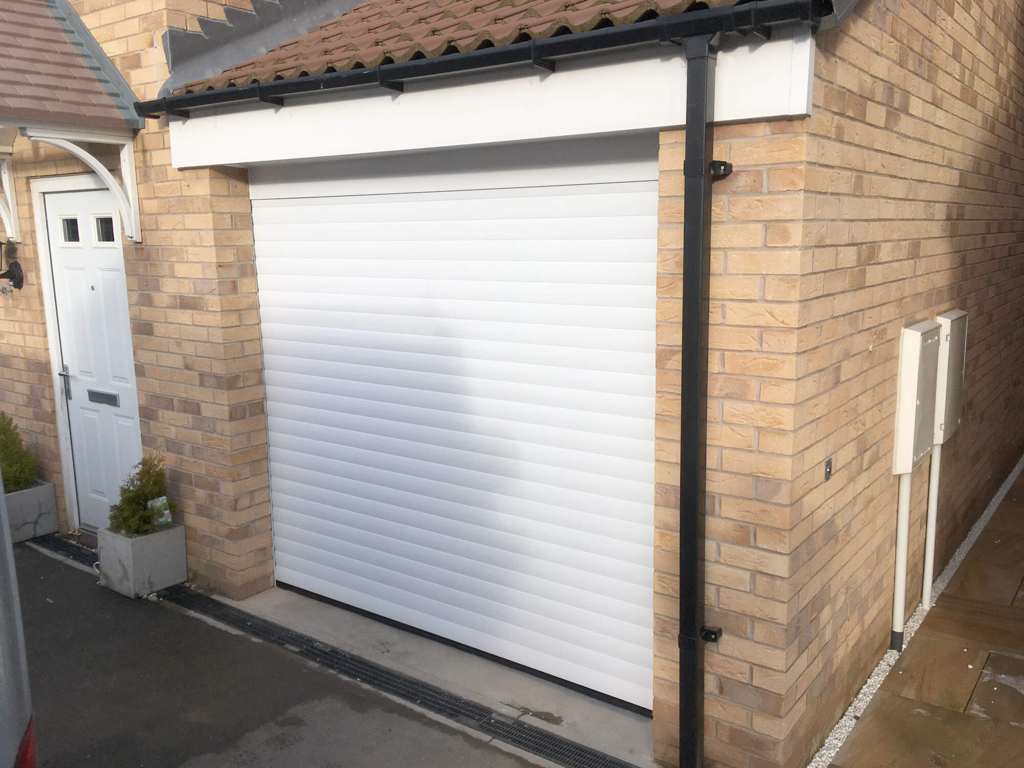Insulated garage door finished in white